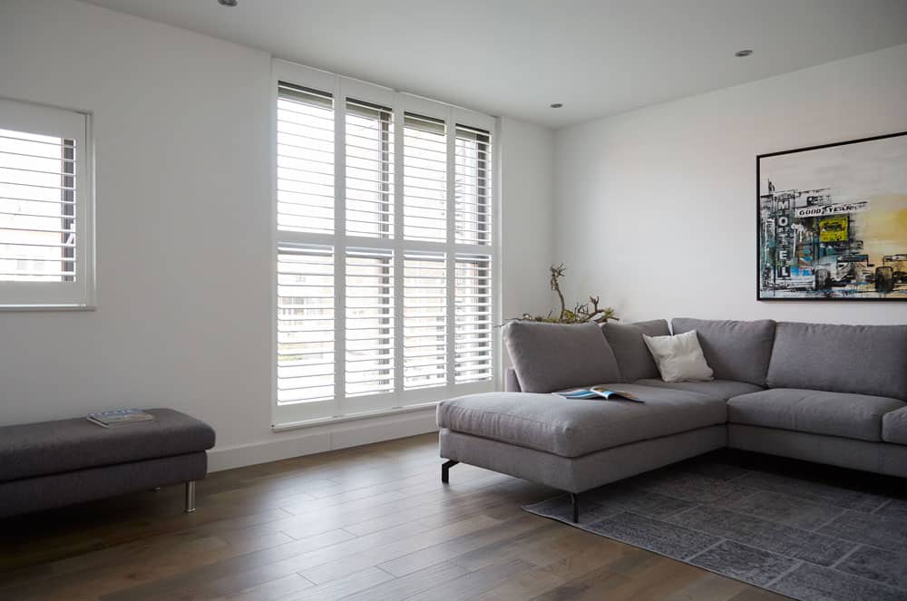 White Shutter With Gray Chair — Timber Tec Shutters In Ballina, NSW