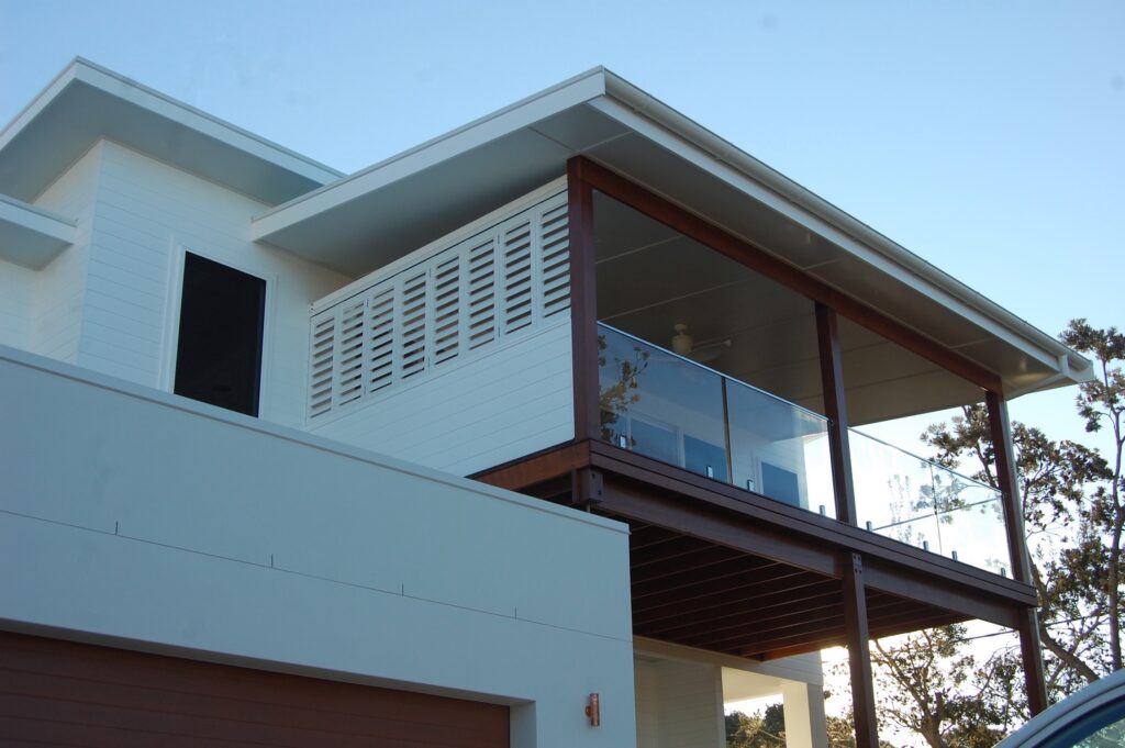White External Aluminium Shutters on the side of the balcony — Timber Tec Shutters In Ballina, NSW